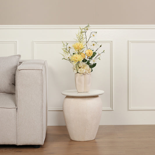 Künstlicher Blumenstrauß Buttercup von Lumisa’s Choice in Gelb und Weiß in cremefarbener Vase auf Beistelltisch im modernen Wohnzimmer.