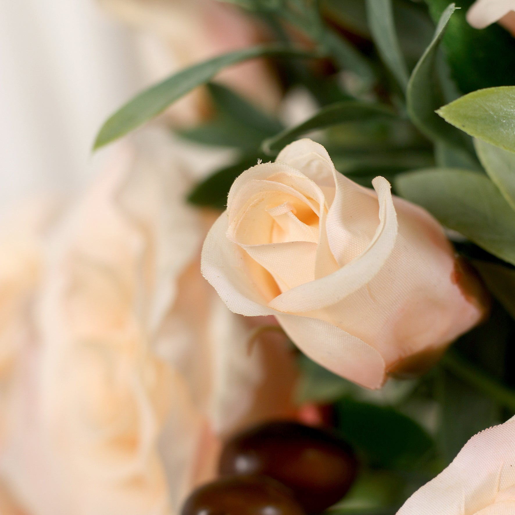 Detailbild einer Rose vom künstlichen Blumenstrauß Rose Mono Bouquet Apricot von Lumisa’s Choice mit apricotfarbenen Blüten und Olivenzweigen als stilvolle Dekoration.