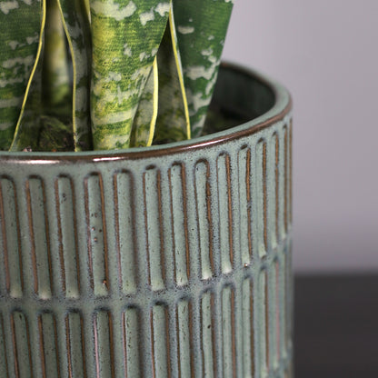 Detailbild vom Topf der künstlichen Grünpflanze Sansevieria in grünem Keramiktopf von Lumisa’s Choice.